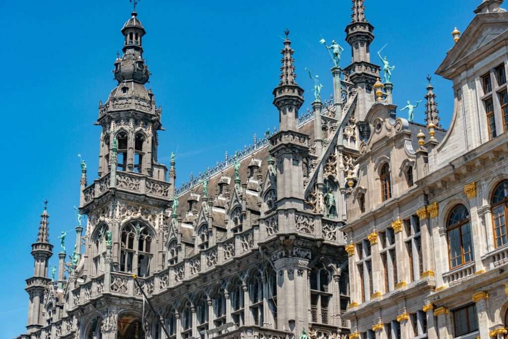 The stunning neo-gothic architecture of the Brussels City Museum against a clear blue sky.