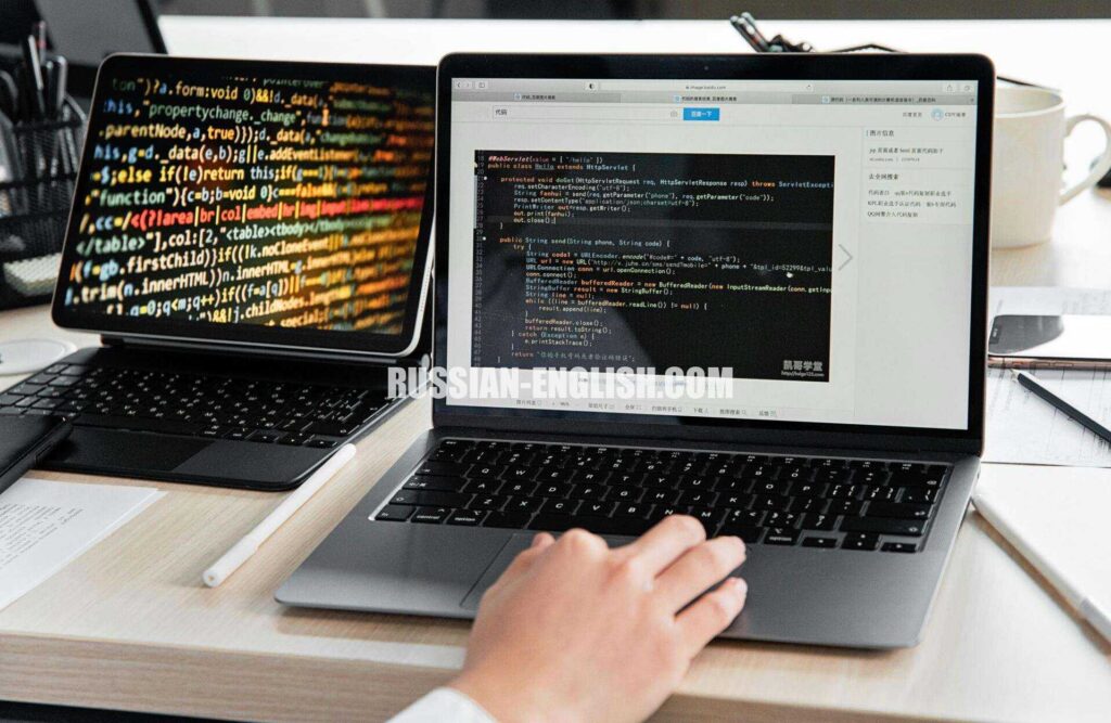 A developer writing code on a laptop, displaying programming scripts in an office environment.
